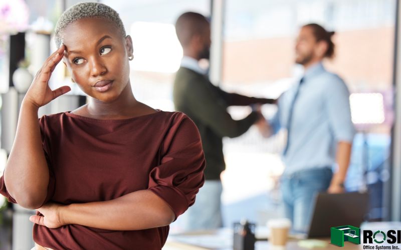 Woman Annoyed in the Office due to other people talking loudly 