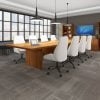 Studio photography of an Offices to Go conference room, with large paned windows. A 144" long rectangular conference table is in the center, with 4 high back plush chairs placed at each side of it. At the head of the table is a set of bookcases and storage cabinets along the wall. A flat screen monitor is placed on the surface above. The furniture is using an Autumn Walnut finish.