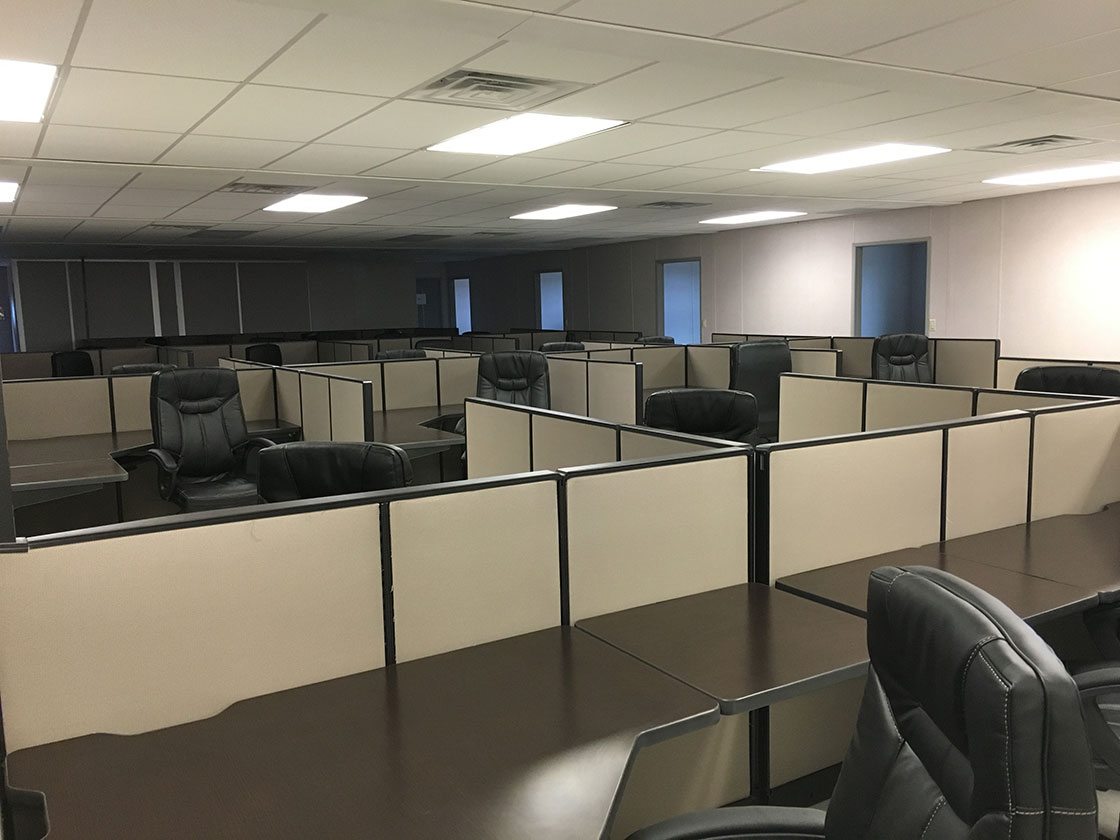 An office full of used office cubicles