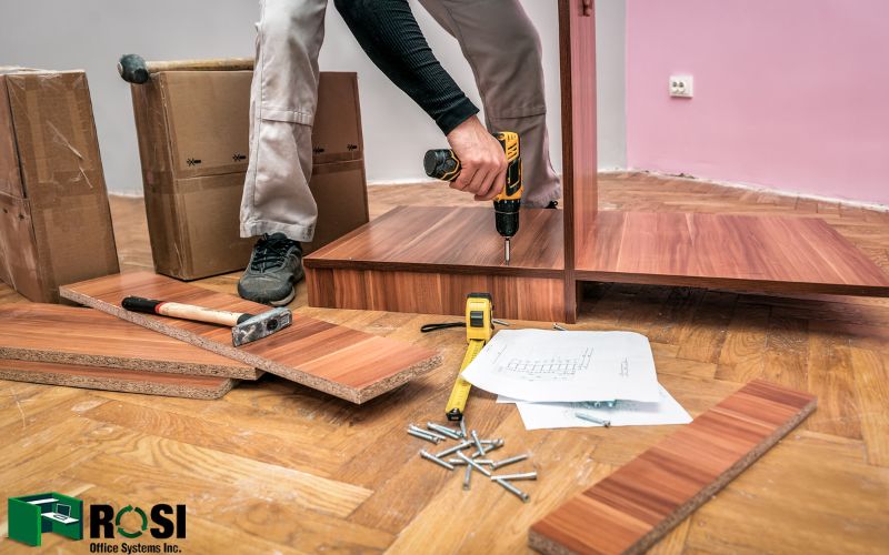 A man is installing cubicles