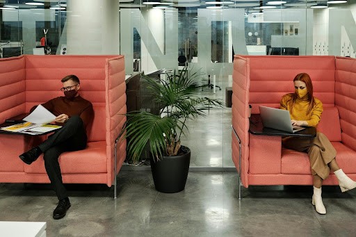 Two private cubicles with a man and lady working in them