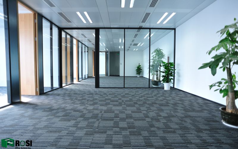 Empty modern office with glass soundproofing partitions and plants