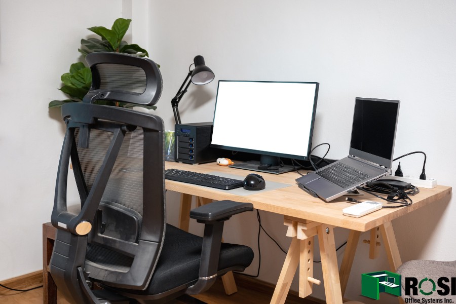 Wooden desk with laptop, display, mouse, lamp, ergonomic chair 